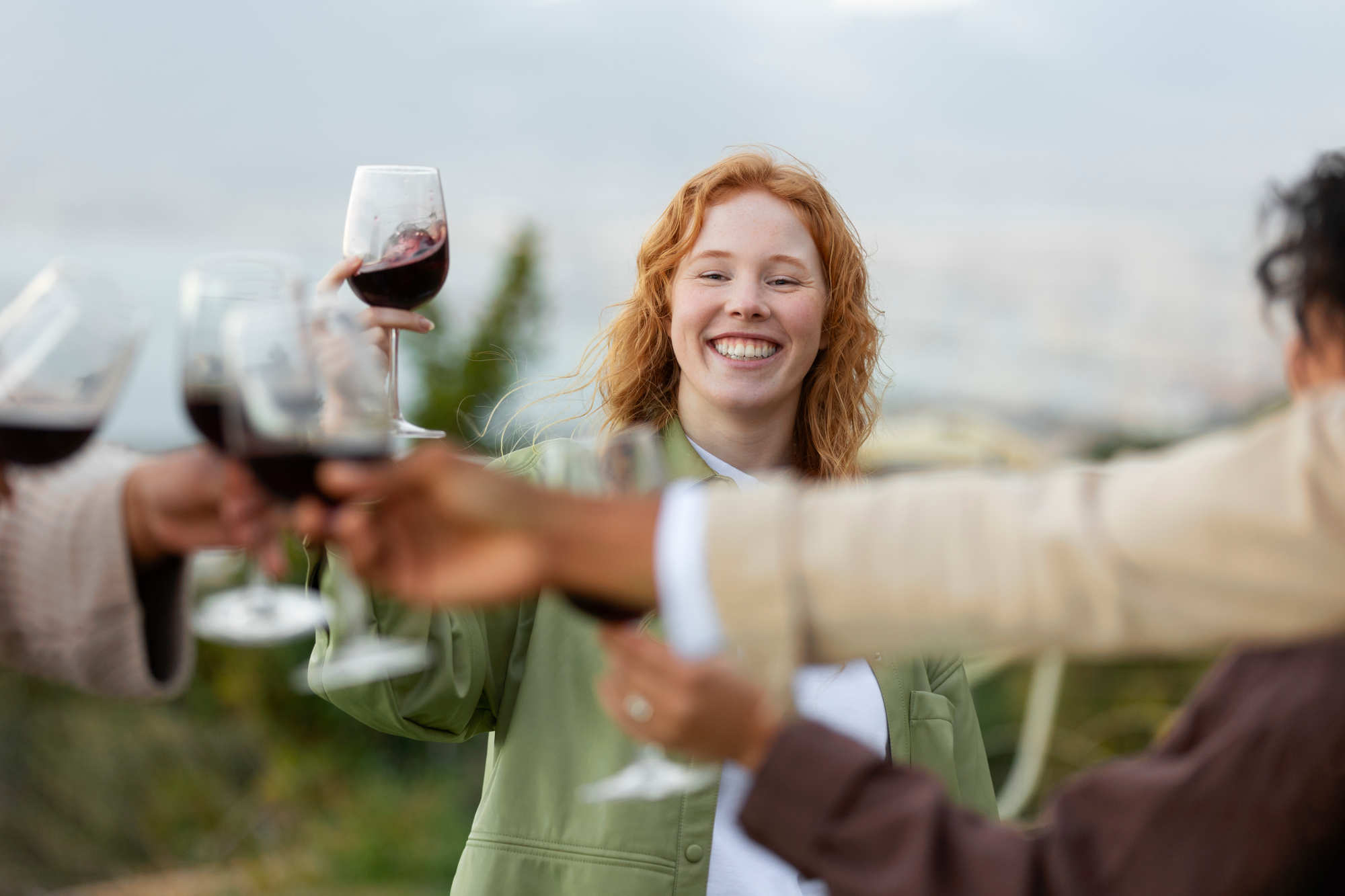 Friends discovering and toasting with glasses of wine outdoors — exploring underrated and hidden gem wines together