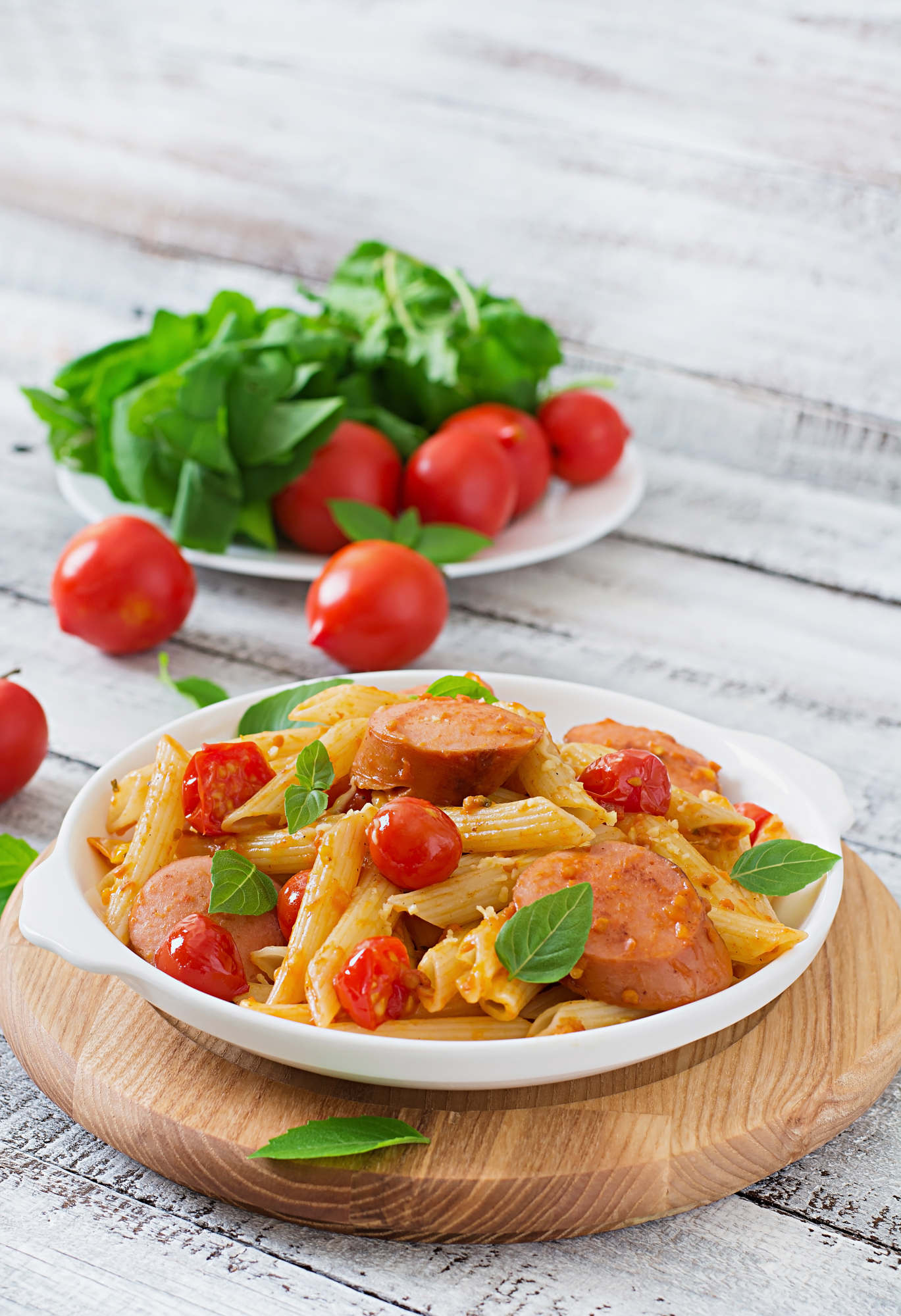 Penne pasta with tomato sauce, sausage and basil — tomato-based pasta sauces are the most forgiving for wine pairing and call for high-acid Italian reds
