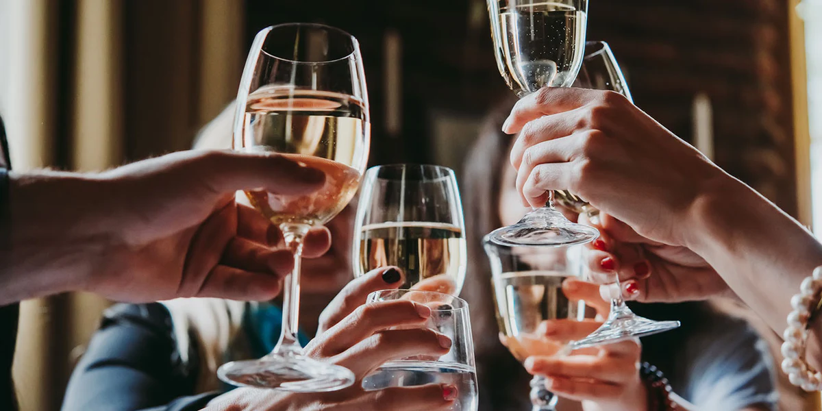 Wine glasses raised at a tasting — professional tasters use a four-step systematic method to evaluate every wine with the same discipline