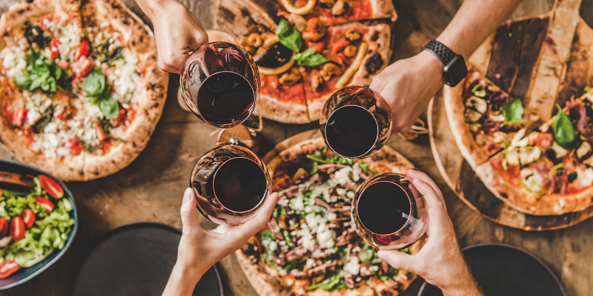 Wine and food on a wooden barrel — Italian wines follow the regional pairing principle with pizza perfectly