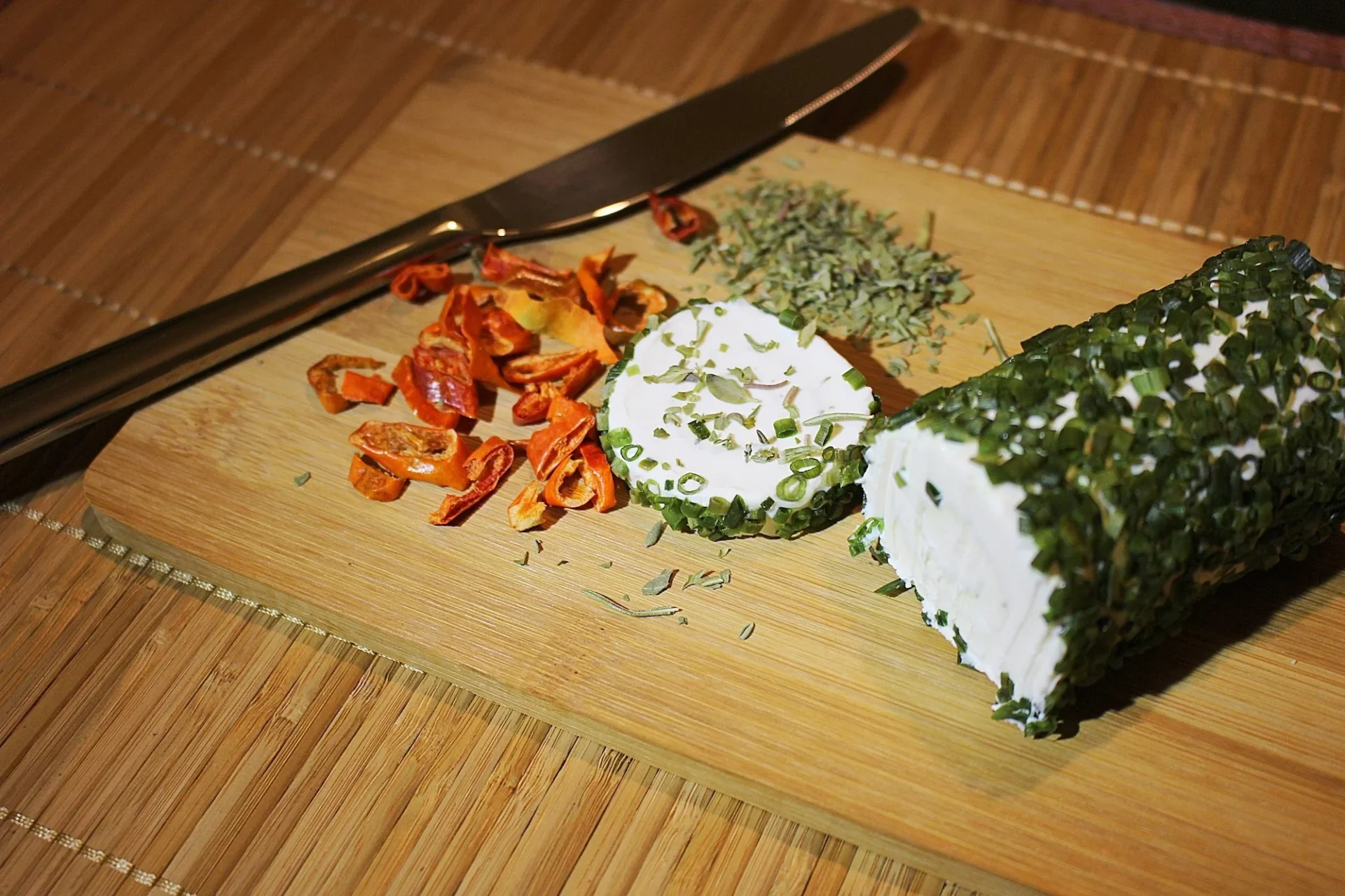 A goat cheese log coated with fresh herbs — herb-coated chèvre pairs beautifully with crisp Sauvignon Blanc or a dry Provençal rosé
