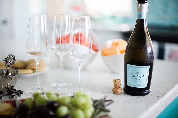 Close-up of wine bottles on a white background — sparkling wine bottles from different regions compared
