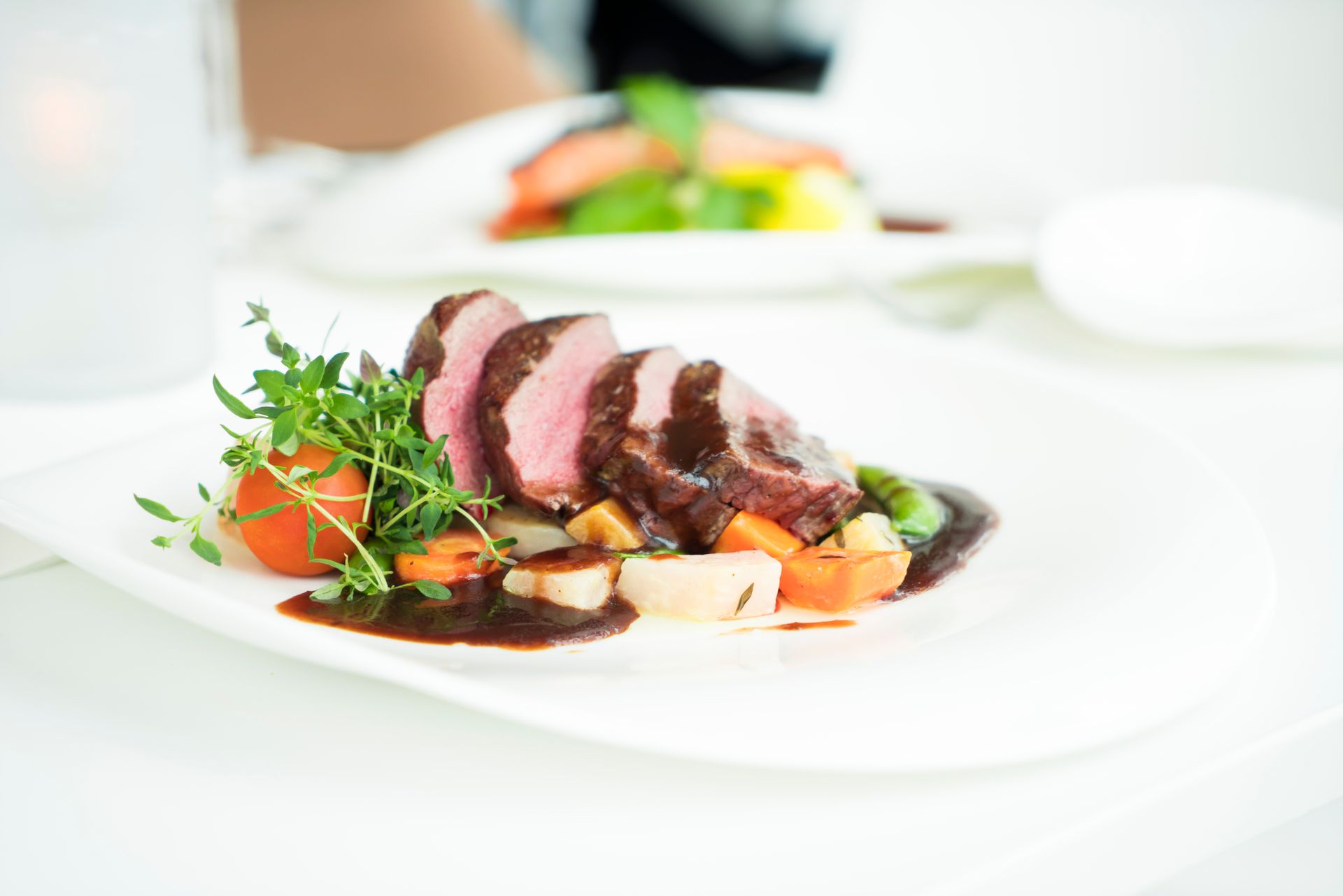 A grilled lamb cut served with lemon and herbs — the cooking method and seasoning are the key variables when choosing wine for lamb