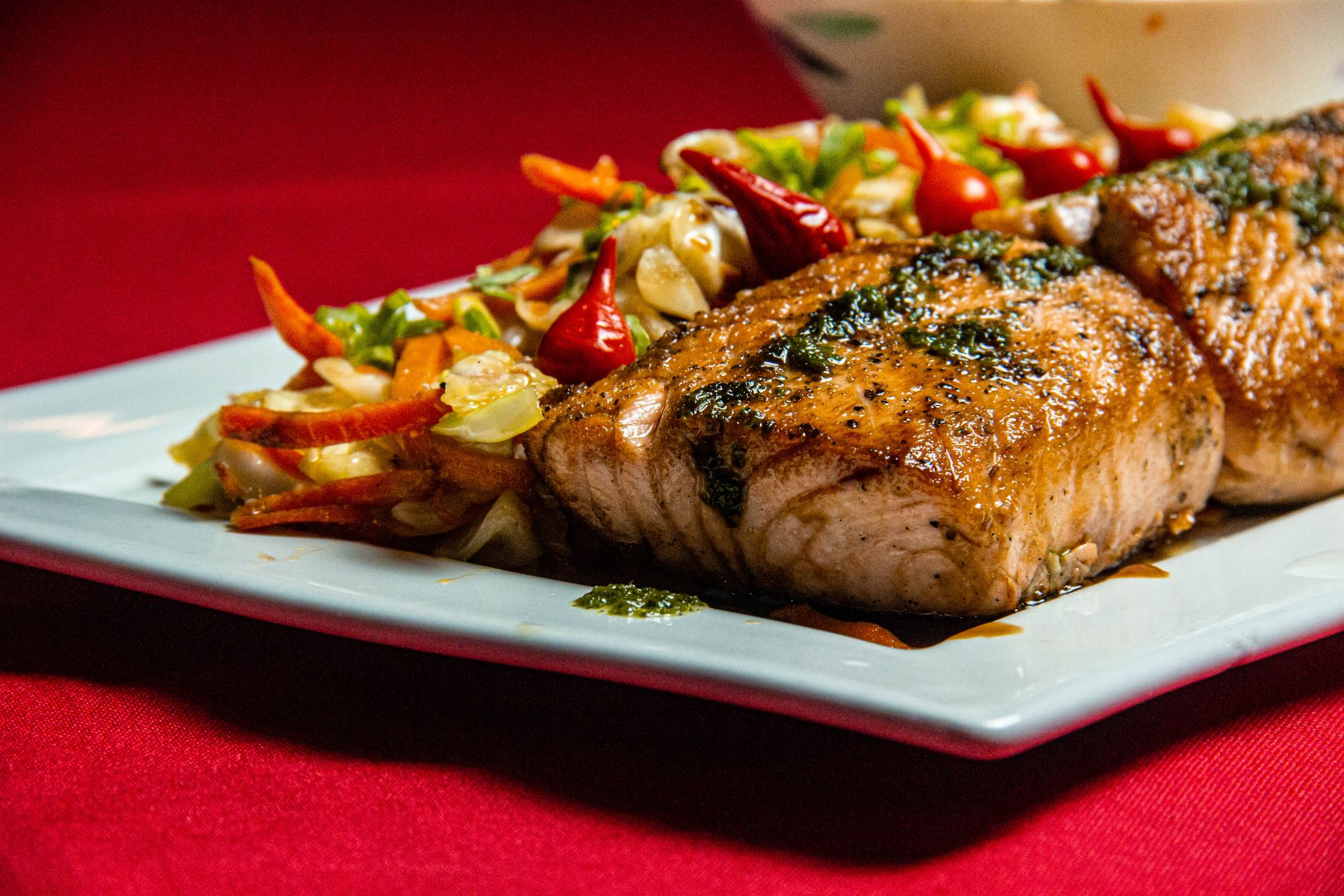 Pan-seared salmon fillet with fresh herbs on a plate — salmon is one of the most versatile fish for wine pairing