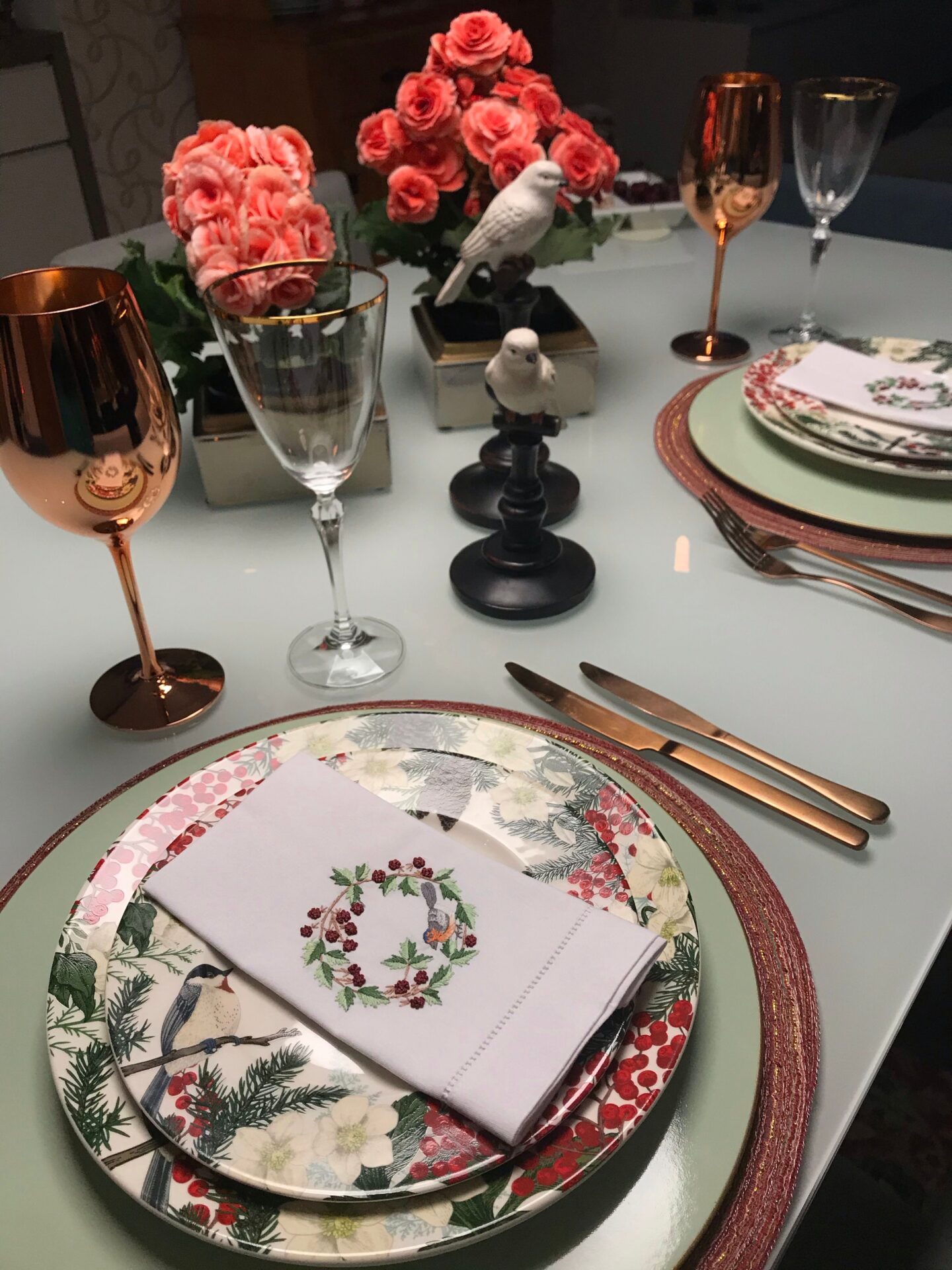 A fine dining table setting with multiple wine glasses